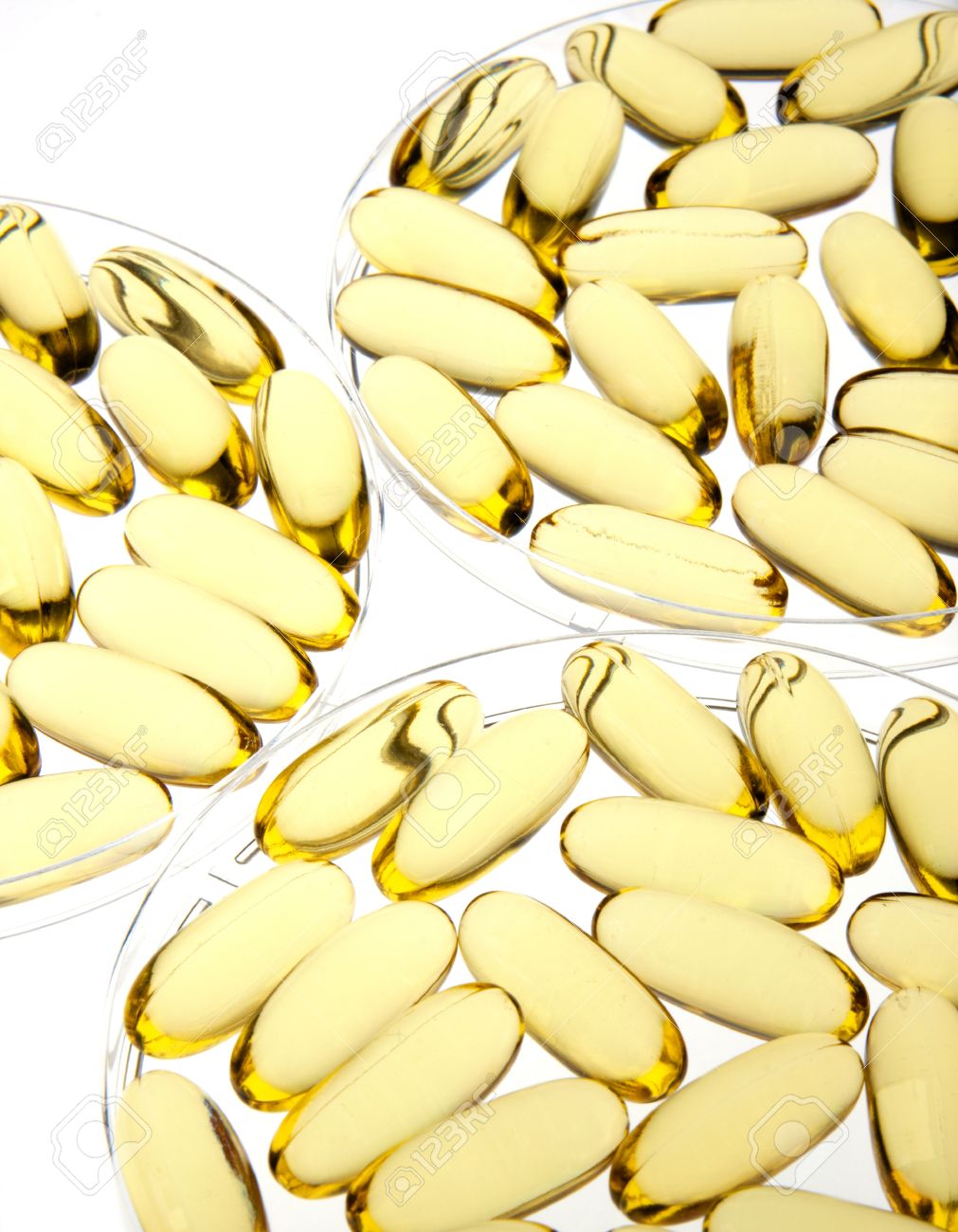 8826600-Gold-pills-or-capsules-backlit-on-white-for-medical-or-science-use-in-petri-dishes-Stock-Photo