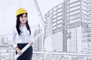 Beautiful young female architect holding blueprint on construction drawing background